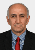 Middle-aged balding man wearing a dark pinstripe suit, blue striped shirt, and red tie.